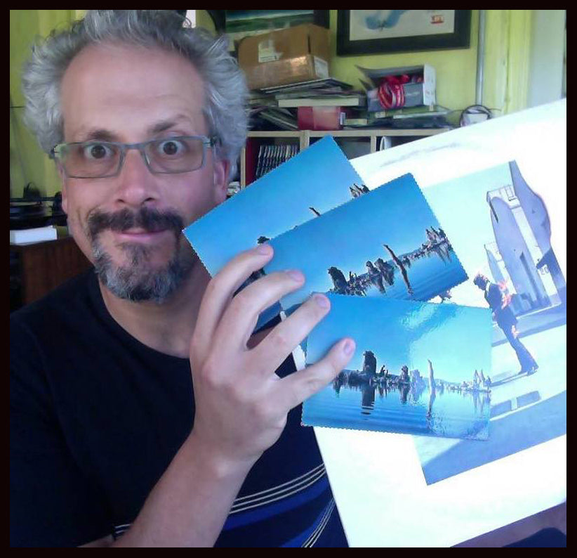 Luke holding three postcards from Pink Floyd's Wish You Were Here LP